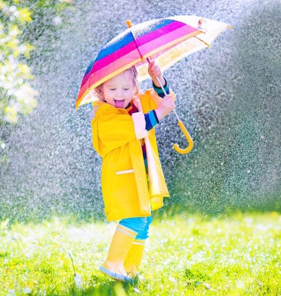 child holding colorful kids umbrella